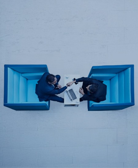 Two consultants meeting across a table, seen from above